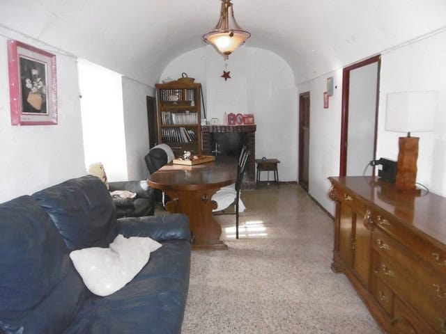 Cozy interior of a cave house located in El Margen, Granada, featuring rustic furniture and unique a.