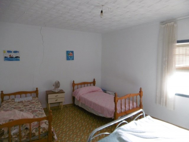 Charming rural property interior in Don Pedro, Jaen with simple furnishings and natural light.