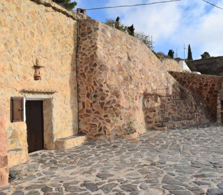 Unique cave house in Carramaiza, Granada with rustic stone walls and traditional architecture.