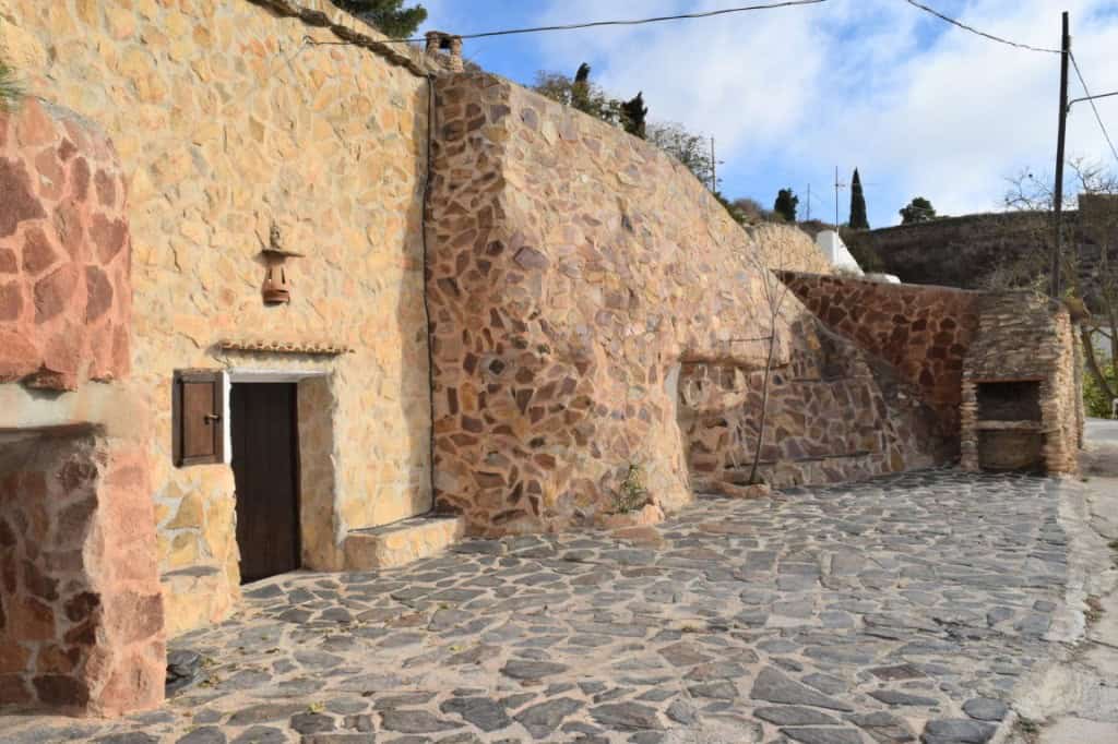 Unique cave house in Carramaiza, Granada with rustic stone walls and traditional architecture.