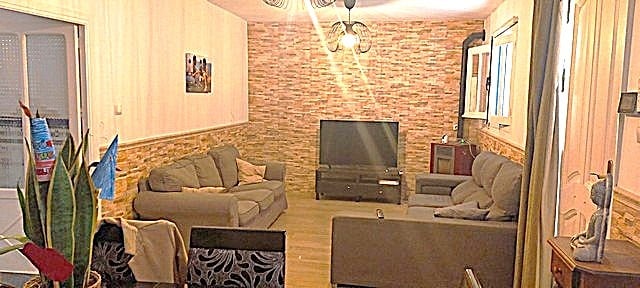 Interior view of a cozy town house living room in Purchena, Almeria, with comfortable sofas and mode.