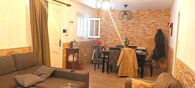 Bright interior of a town house in Purchena, Almeria, featuring a living room and dining area with r.
