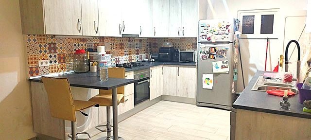 Spacious kitchen in a town house located in Purchena, Almeria, featuring modern appliances and color.