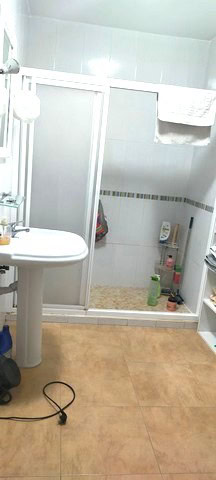 Cozy bathroom in a town house in Purchena, Almeria, featuring a shower, sink, and essential amenitie.