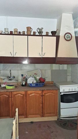 Town House Kitchen in Purchena, Almeria with rustic wooden cabinets and vintage decor.