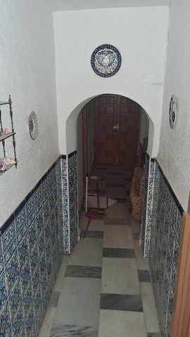 Entrance hallway of a traditional town house in Purchena, Almeria, featuring decorative tiles and wo.