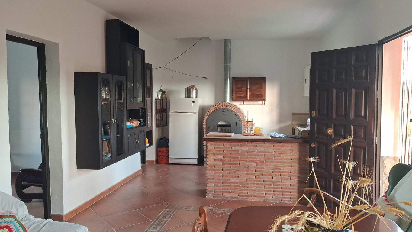 Charming rural property interior in Freila, Granada, featuring a cozy living space with a brick oven.
