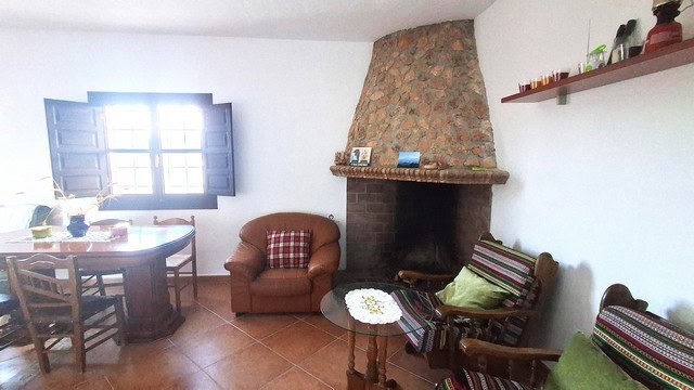 Charming rural home interior with fireplace in Freila, Granada. Cozy living space perfect for countr.