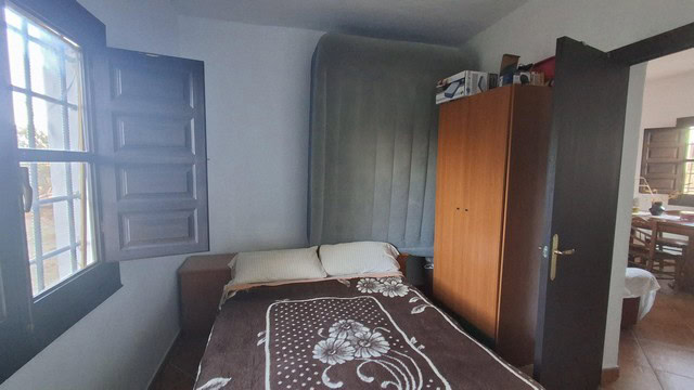 Beautiful rural property in Freila, Granada, featuring a cozy bedroom with natural light and scenic.
