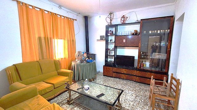 Charming village property in Armuna, Almeria, featuring a cozy living room with vintage furniture an.