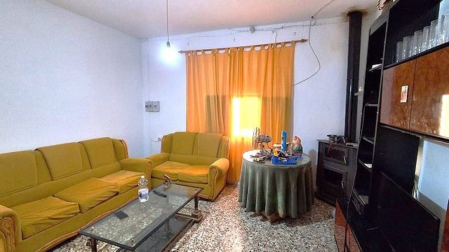 Charming village home in Armuna, Almeria with cozy living room and traditional decor.