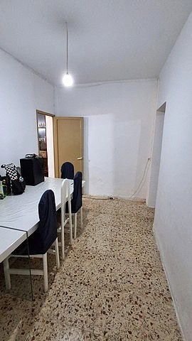 Interior of a village property in Armuna, Almeria, showing a simple dining area with white walls and.