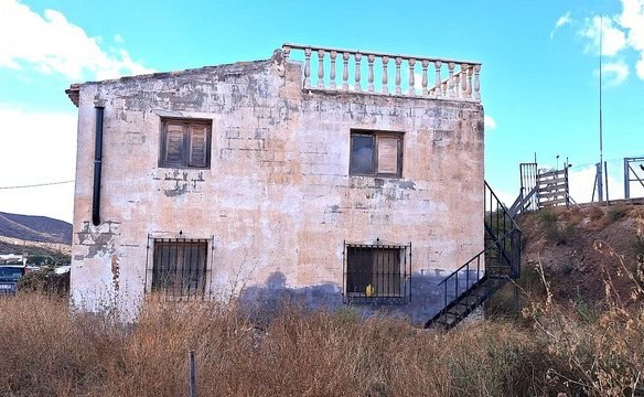 Rural property in Albox, Almeria featuring a rustic house with outdoor terrace and scenic countrysid.