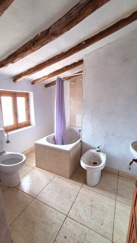 Bathroom with bathtub, bidet, and toilet in rural Almeria property.
