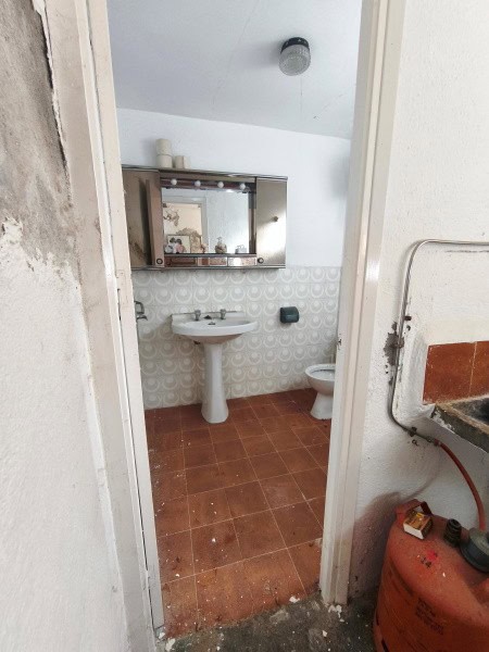 Charming cave house bathroom in Baza, Granada, featuring a sink, mirror, and rustic decor. Perfect f.