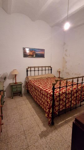Charming village bedroom with vintage iron bed and simple decor in Seron, Almeria.