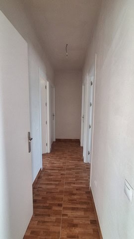 Interior hallway of a rural property in Seron, Almeria, showing white walls and wooden flooring.
