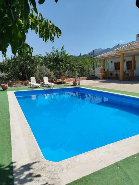 Beautiful pool at rural property in Quesada, Jaen with mountain views and outdoor seating.