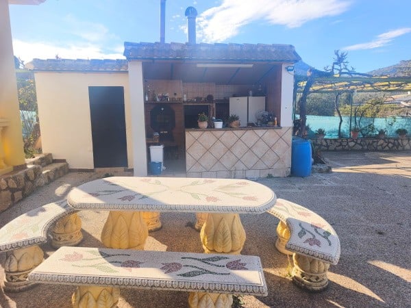 Outdoor patio with lake view and seating area in rural Quesada, Jaen.