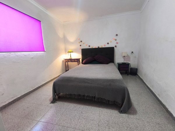 Cozy bedroom in village property, Hinojares, Jaen with simple decor and ambient lighting.