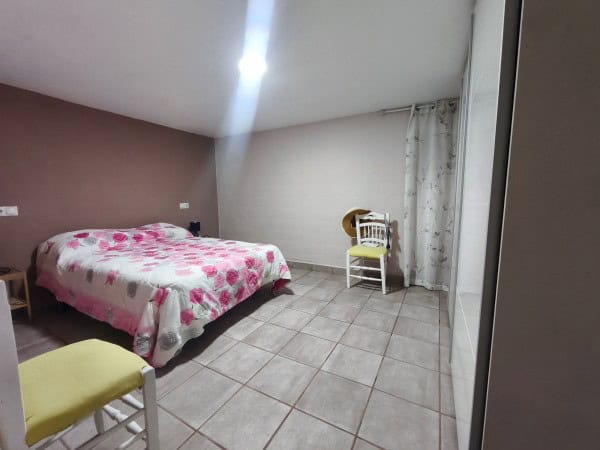 Charming bedroom in rural Quesada property with simple decor and natural light.