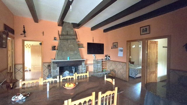 Charming rural home in Purchena, Almeria with cozy living room, fireplace, and traditional decor. Pe.