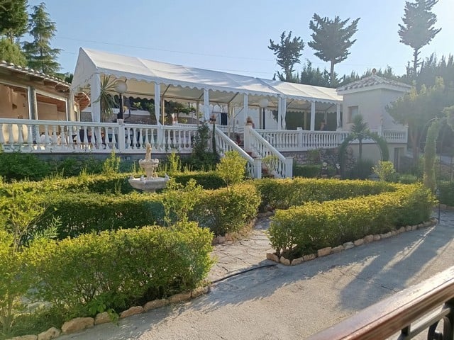 Villa in Cullar, Granada with lush gardens and outdoor terrace.