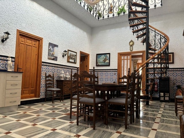 Charming interior of a villa in Cullar, Granada with traditional decor and a spiral staircase. Perfe.