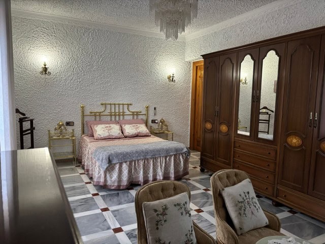 Charming bedroom in a villa located in Cullar, Granada, featuring classic furniture and elegant deco.