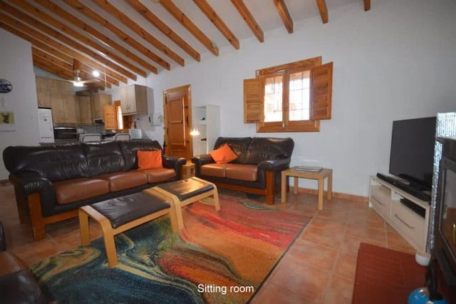 Comfortable sitting room with leather sofas and wooden accents in Uleila del Campo, Almeria.
