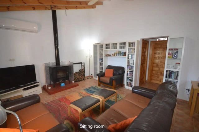 Comfortable sitting room with leather sofas and a fireplace in Uleila del Campo, Almeria.