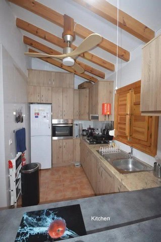Cozy kitchen in a villa located in Uleila del Campo, Almeria, featuring wooden accents and modern ap.
