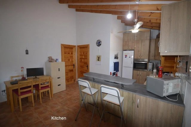 Modern kitchen in a villa located in Uleila del Campo, Almeria, with wooden ceiling and contemporary.