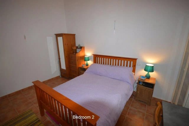 Cozy bedroom in a villa located in Uleila del Campo, Almeria, featuring wooden furniture and simple.