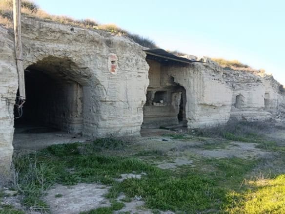 Cave house in Benamaurel, Granada, carved into the hillside with natural rock formations.
