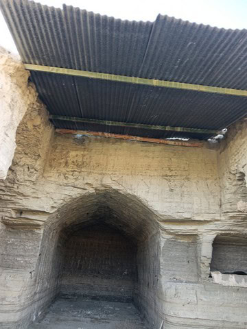 Cave house with a corrugated metal roof in Benamaurel, Granada, showcasing traditional cave dwelling.