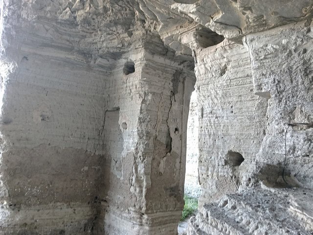 Cave house interior in Benamaurel, Granada, showcasing natural rock walls and unique architecture.