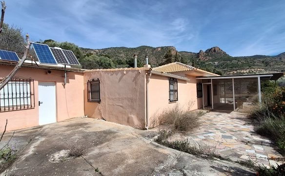 Villa in Urracal with solar panels and scenic mountain views.