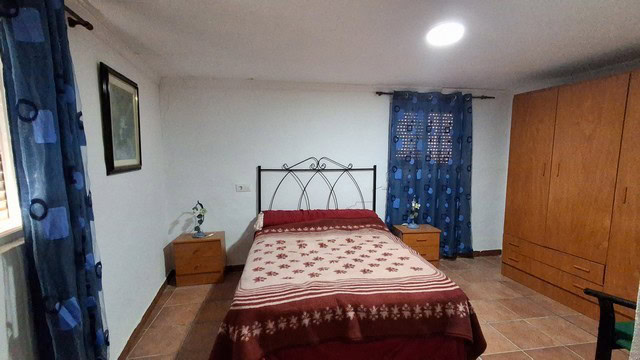 Bright bedroom with double bed and wooden furniture in Urracal, Almeria.