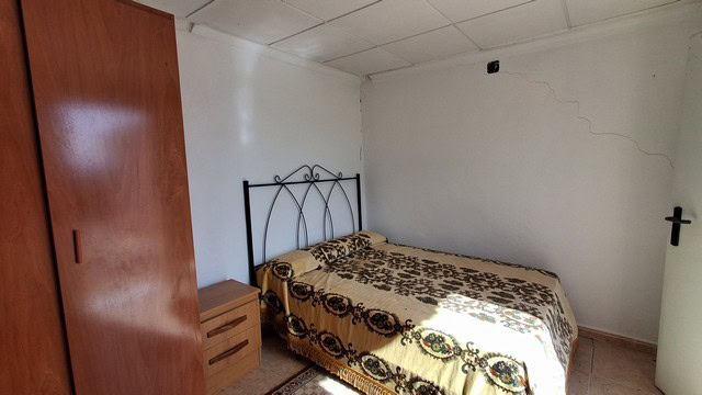 Cozy bedroom in a villa located in Urracal, Almeria with simple furnishings.