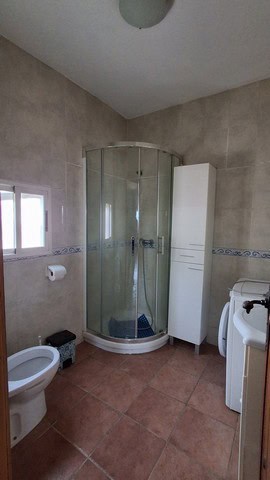 Bathroom with glass shower enclosure in Urracal villa, Almeria.