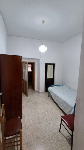 Bedroom in town house, Seron, Almeria with simple furnishings and white walls.
