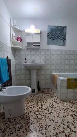 Bright bathroom with sink, bidet, and colorful towels in Seron, Almeria.