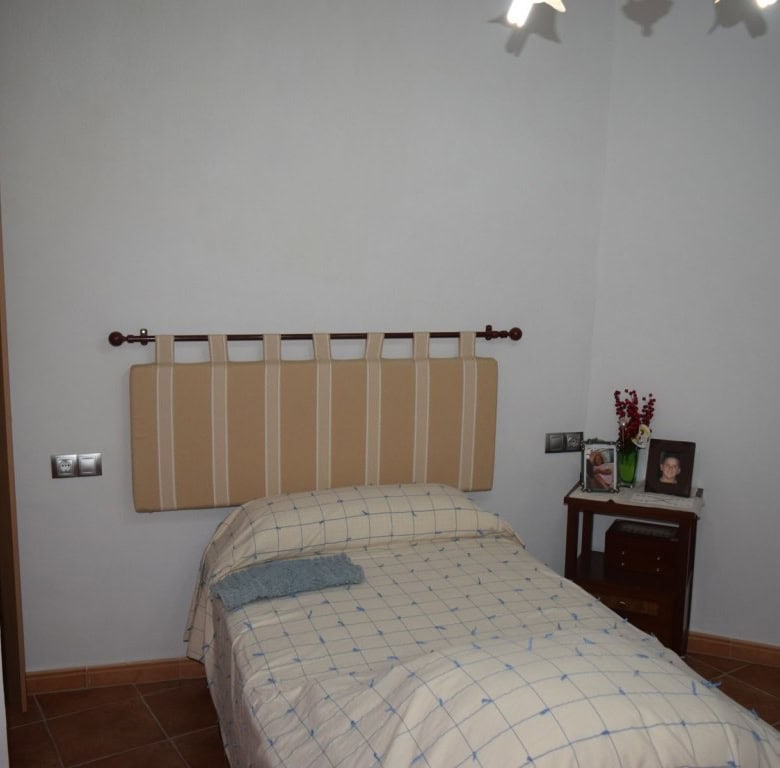 Cozy bedroom in a traditional cave house located in Freila, Granada, offering unique living experien.