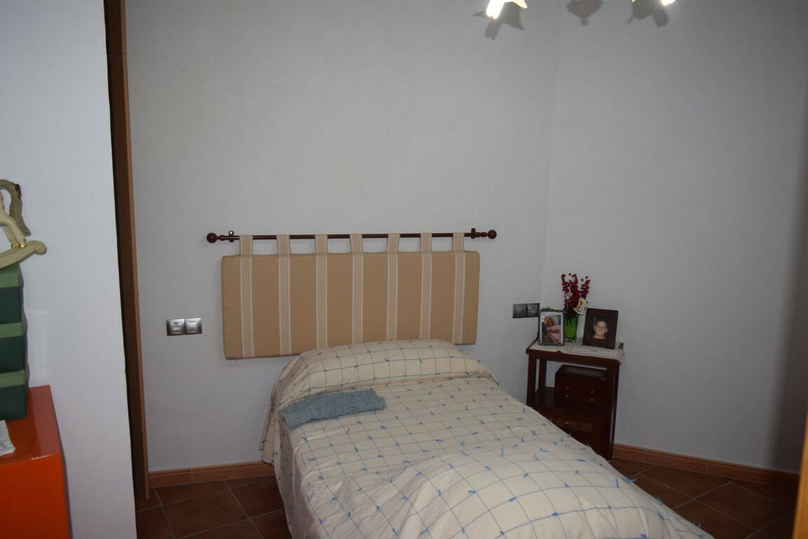Cozy bedroom in a traditional cave house located in Freila, Granada, offering unique living experien.