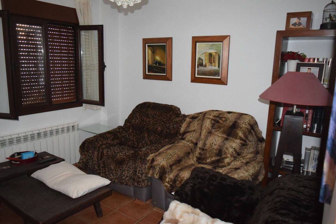 Cave house interior with cozy seating and wooden framed artwork in Freila, Granada.