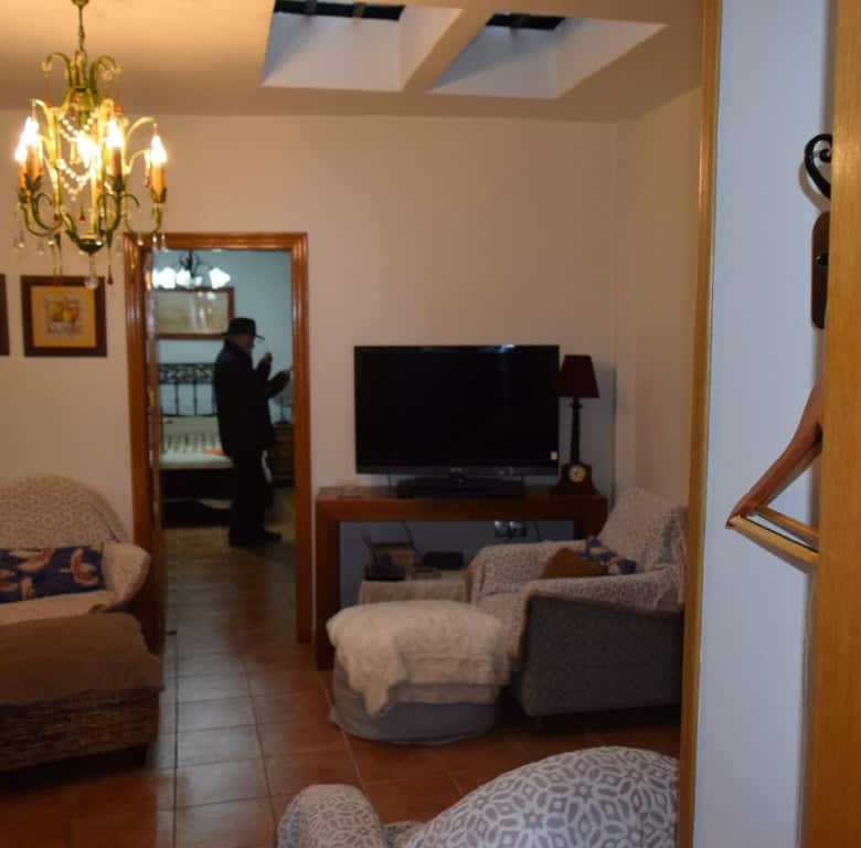 Cozy interior of a cave house in Freila, Granada, featuring traditional decor and comfortable seatin.