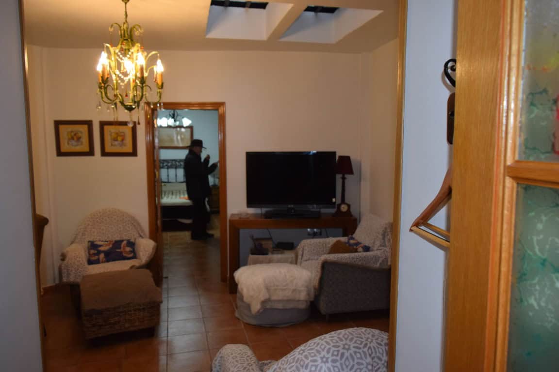 Cozy interior of a cave house in Freila, Granada, featuring traditional decor and comfortable seatin.