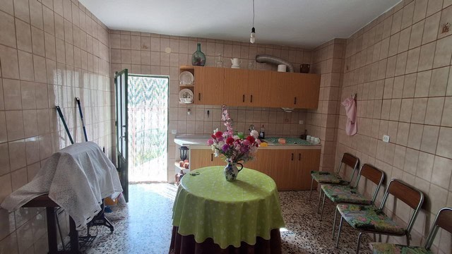 Charming town house interior in Seron, Almeria, featuring a cozy kitchen with a round table and flor.