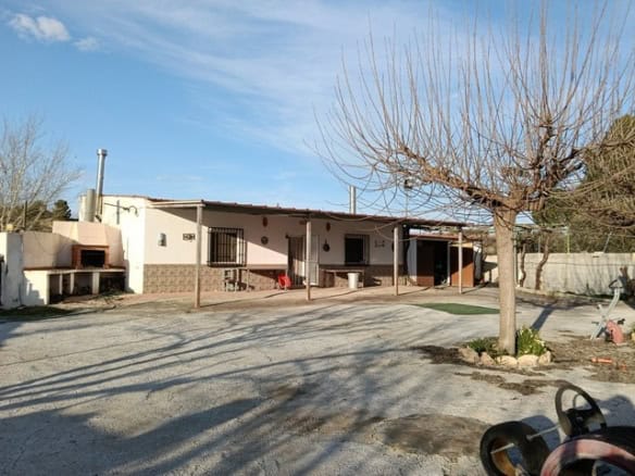 Rural property for sale in Benamaurel, Granada, featuring a traditional house with outdoor space and.